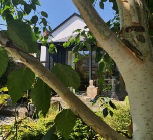 View to scupltured head through silver branches
